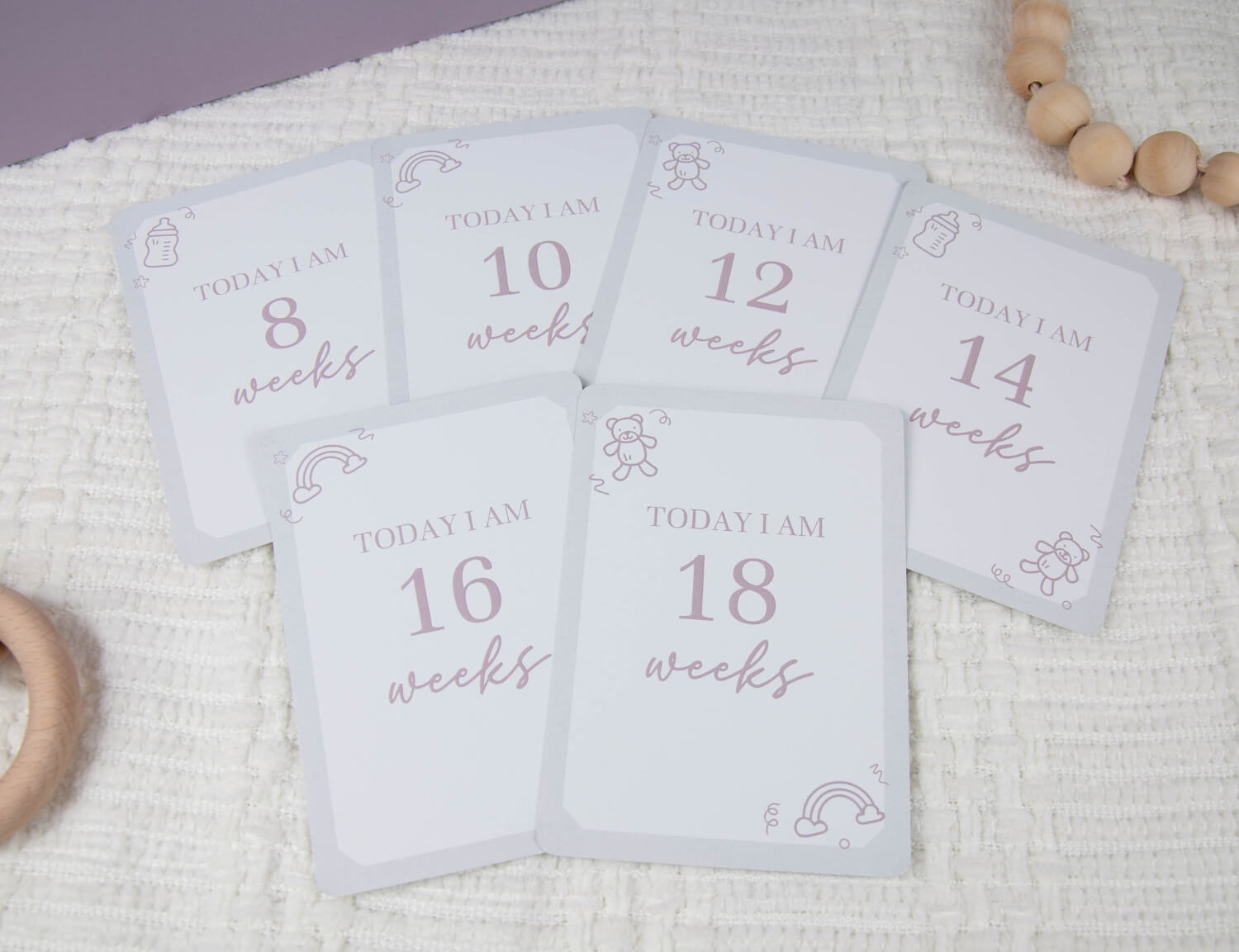 six pregnancy milestone cards displaying the number of weeks pregnant