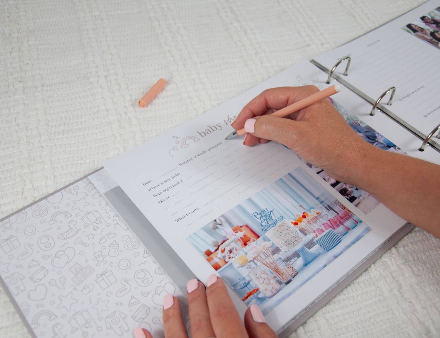 baby shower page in pregnancy journal being filled in