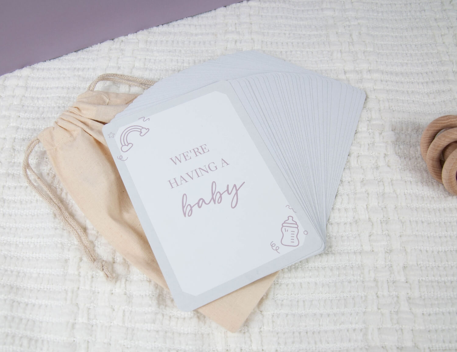 pregnancy milestone card displaying the words we are having a baby
