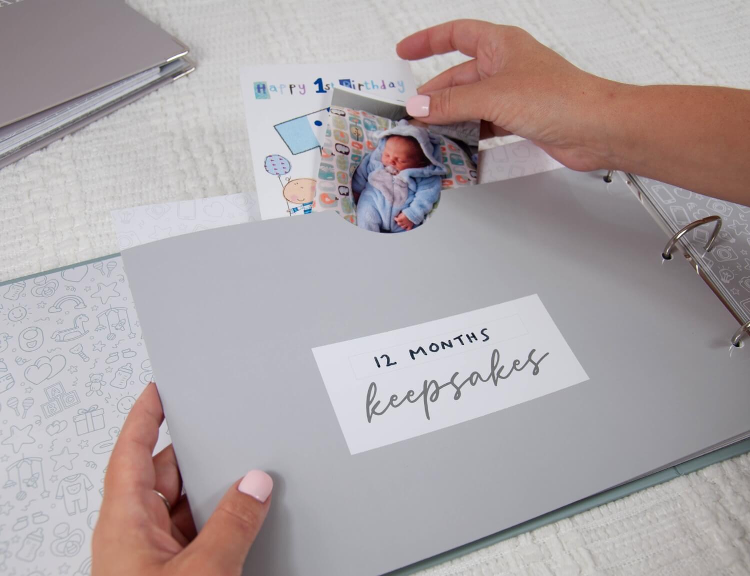 hands placing baby keepsakes in pocket in memory book