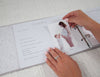 photo being placed in pregnancy journal